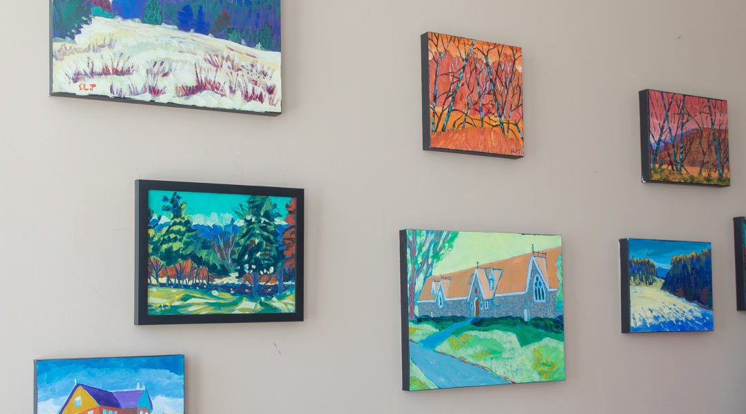Beautiful wall covered in art at Strachan Johnston's Studio 7 pieces of colourful art displayed on a wall